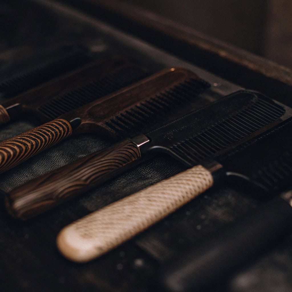 Various wooden hairbrush handles showing different wood grains like Beech, Maple, Bamboo