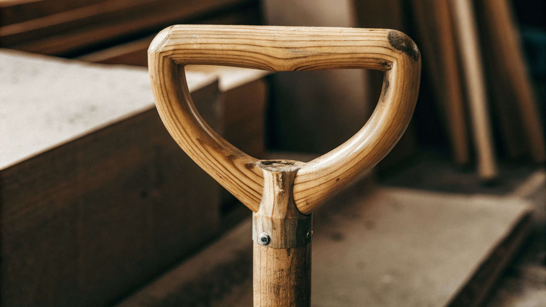 New wooden handle ready to be inserted into an old shovel head socket