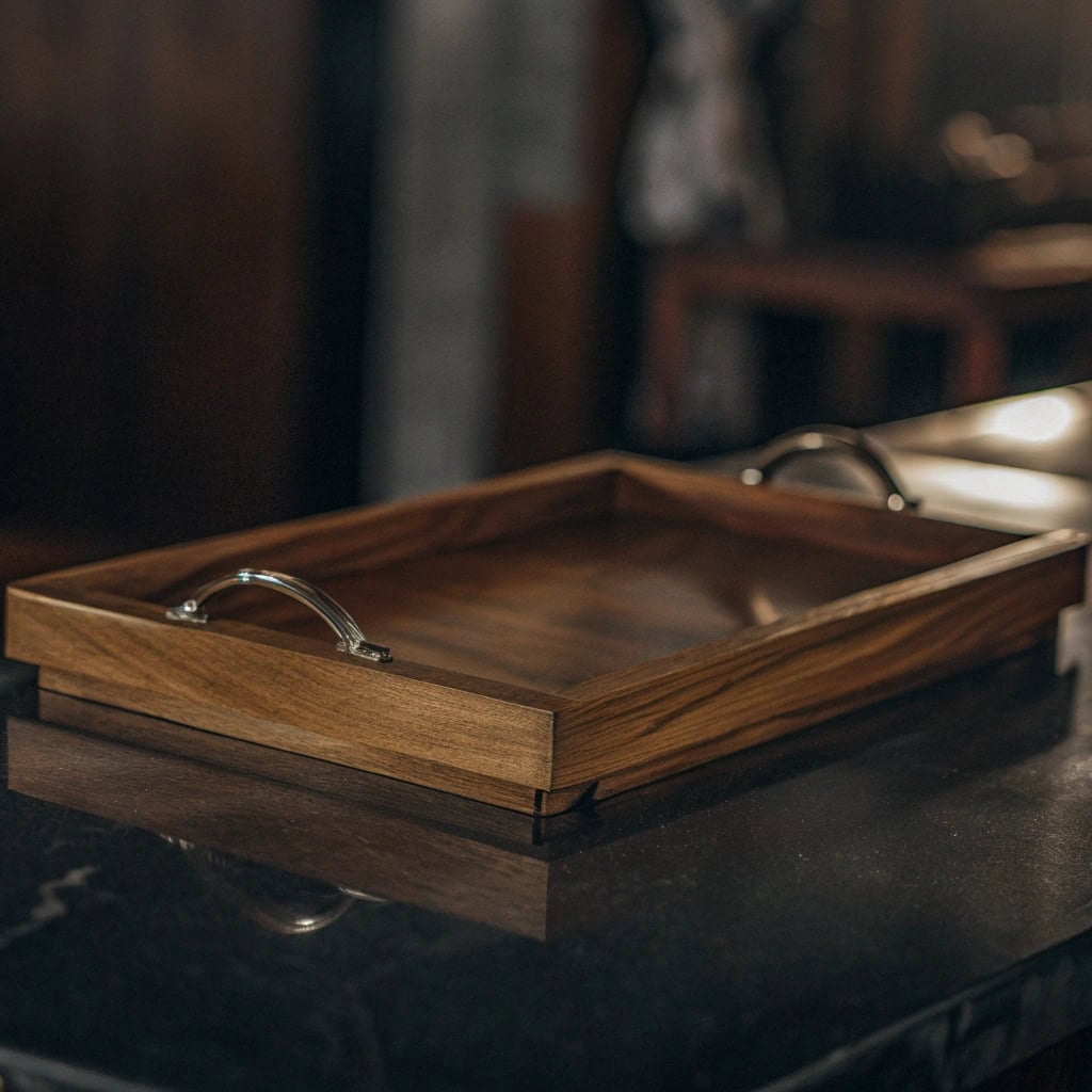 Restaurant server carrying multiple drinks on a sturdy handled tray